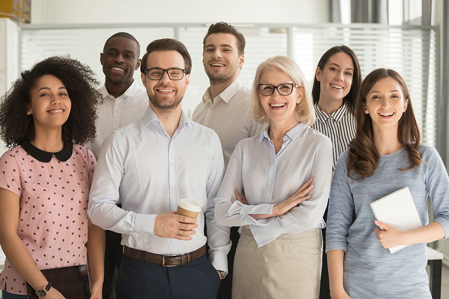 Portrait Of Happy Employees Standing In Office